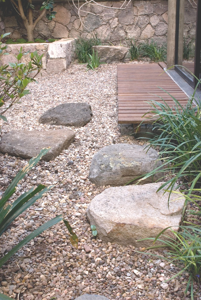 Informal stone for dry garden area in backyard Japanese garden